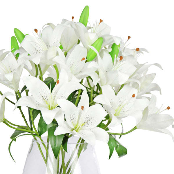 Fake white lily flowers being displayed in a vase for sale