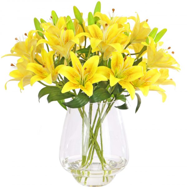 Fake yellow lily arrangement set in a glass vase