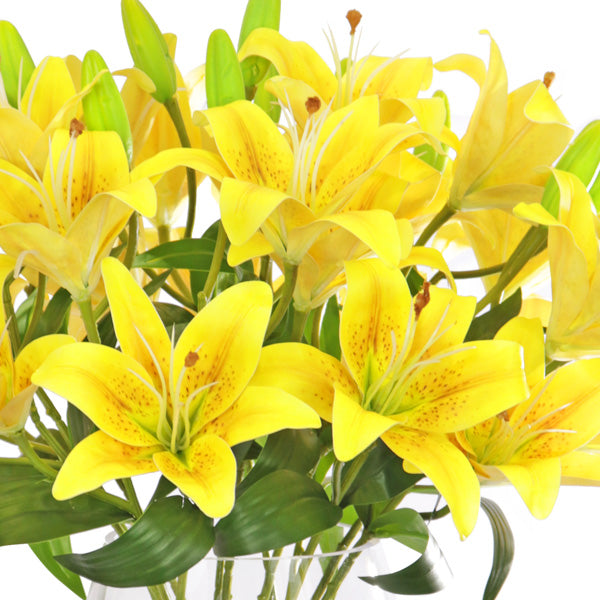 Yellow lilies for sale in a faux arrangement
