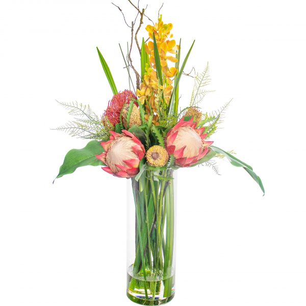 Artificial protea and foliage arrangement set in a glass vase