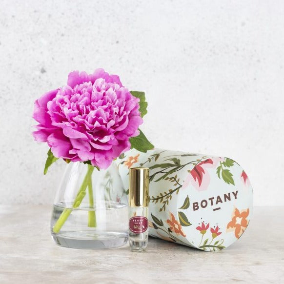 Silk peony flower in vase with floral fragrance spray