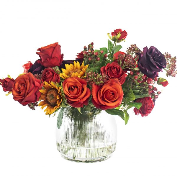 Artificial silk mixed flower arrangement in glass vase