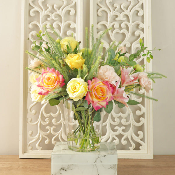 Artificial rose flower arrangement in glass vase