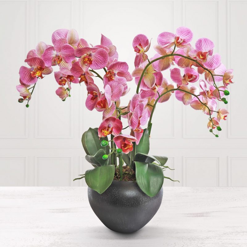 Artificial mauve orchid plant in metal pot