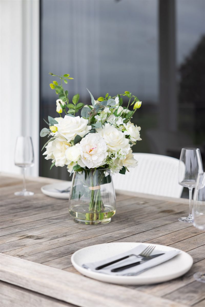 Artificial silk flowers used as centerpiece decoration on table