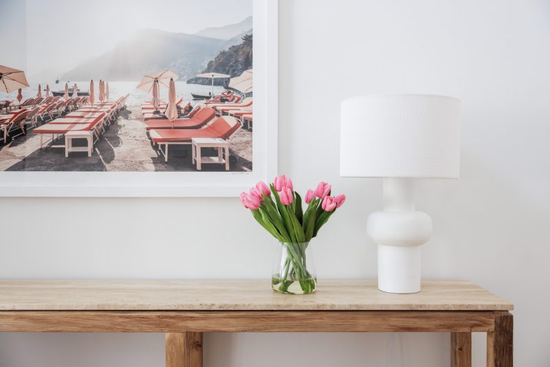 Fake tulip bouquet placed stylishly next to a lamp