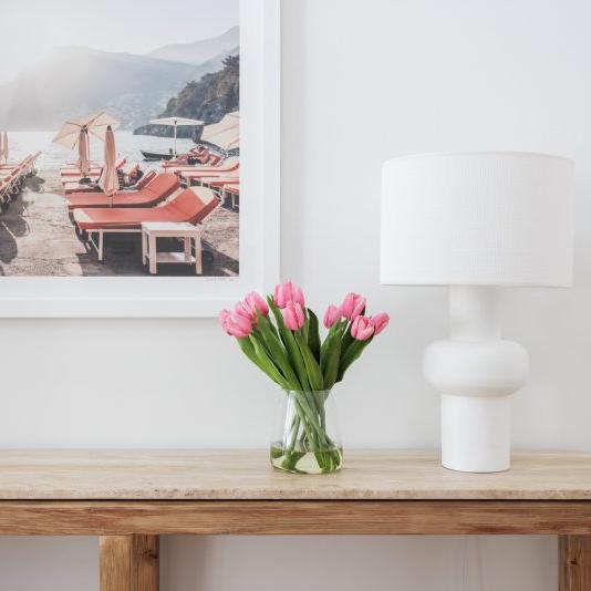 Fake tulip bouquet placed stylishly next to a lamp