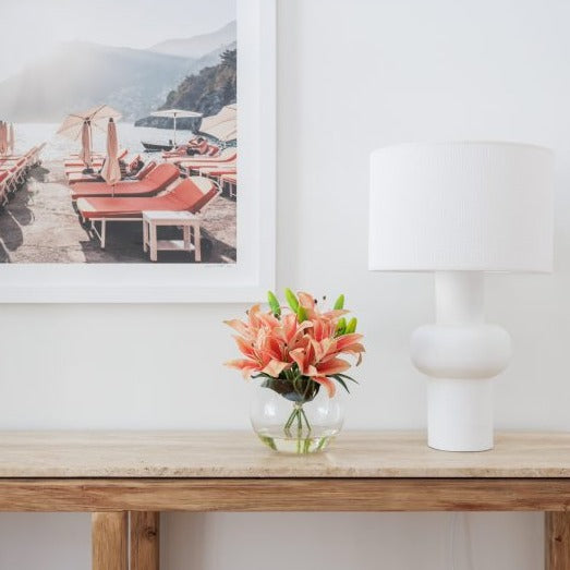 A vibrant and colourful faux lily bouquet placed on a side table