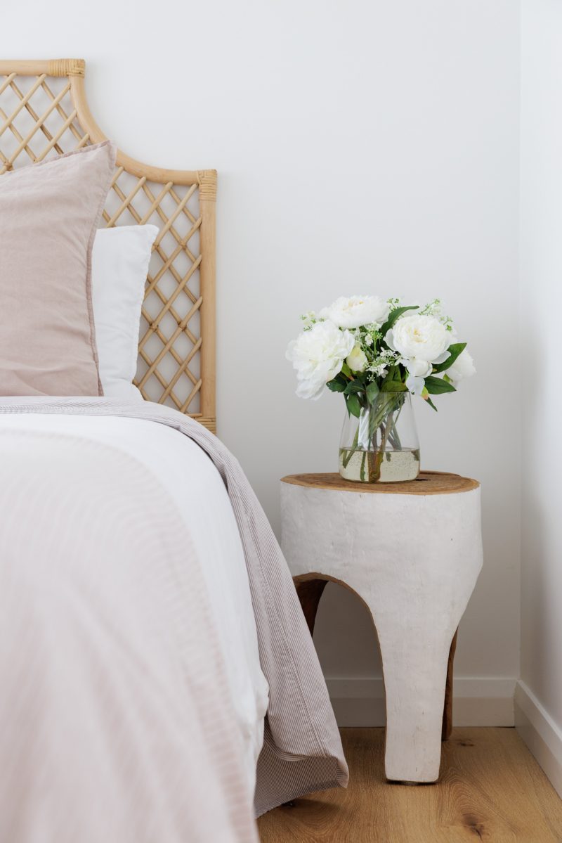 Fake white peony flowers in a bedroom adding a luxury feel
