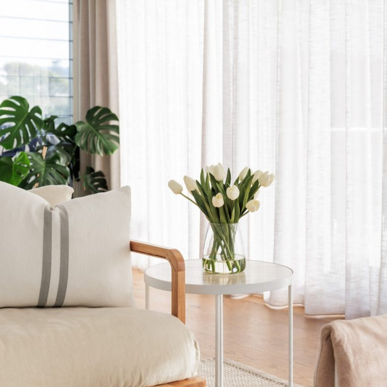 Fake white tulip arrangement on a side table in an Australian home