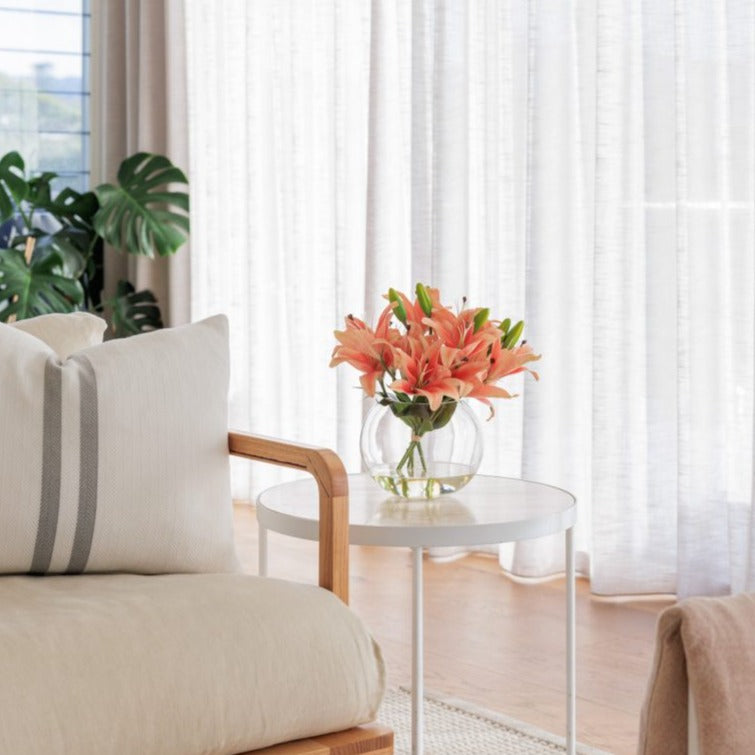 Fake lily arrangement placed on a side table in an Australian home